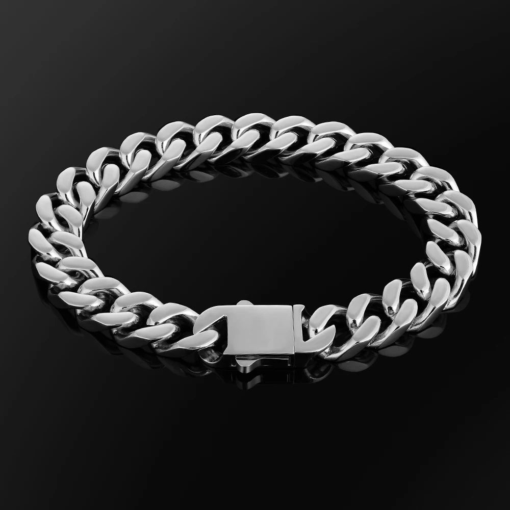 A silver-toned Cuban link chain bracelet with a polished rectangular clasp, displayed on a reflective black surface.