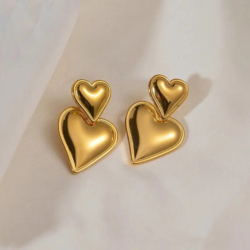 Smooth Heart Drop Earrings – pair of heart earrings on cream background