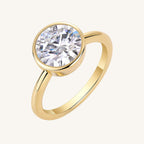Gold ring with a large diamond on a white background