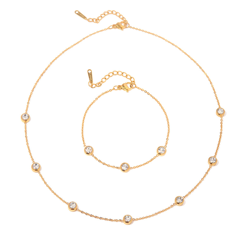 Gold necklace with small round beads on a white background