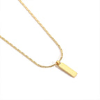 Gold necklace with a rectangular pendant on a white background