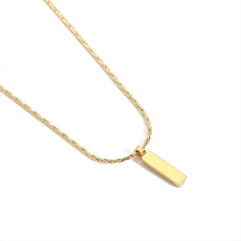Gold necklace with a rectangular pendant on a white background