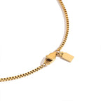 Gold chain necklace with clasp on a white background