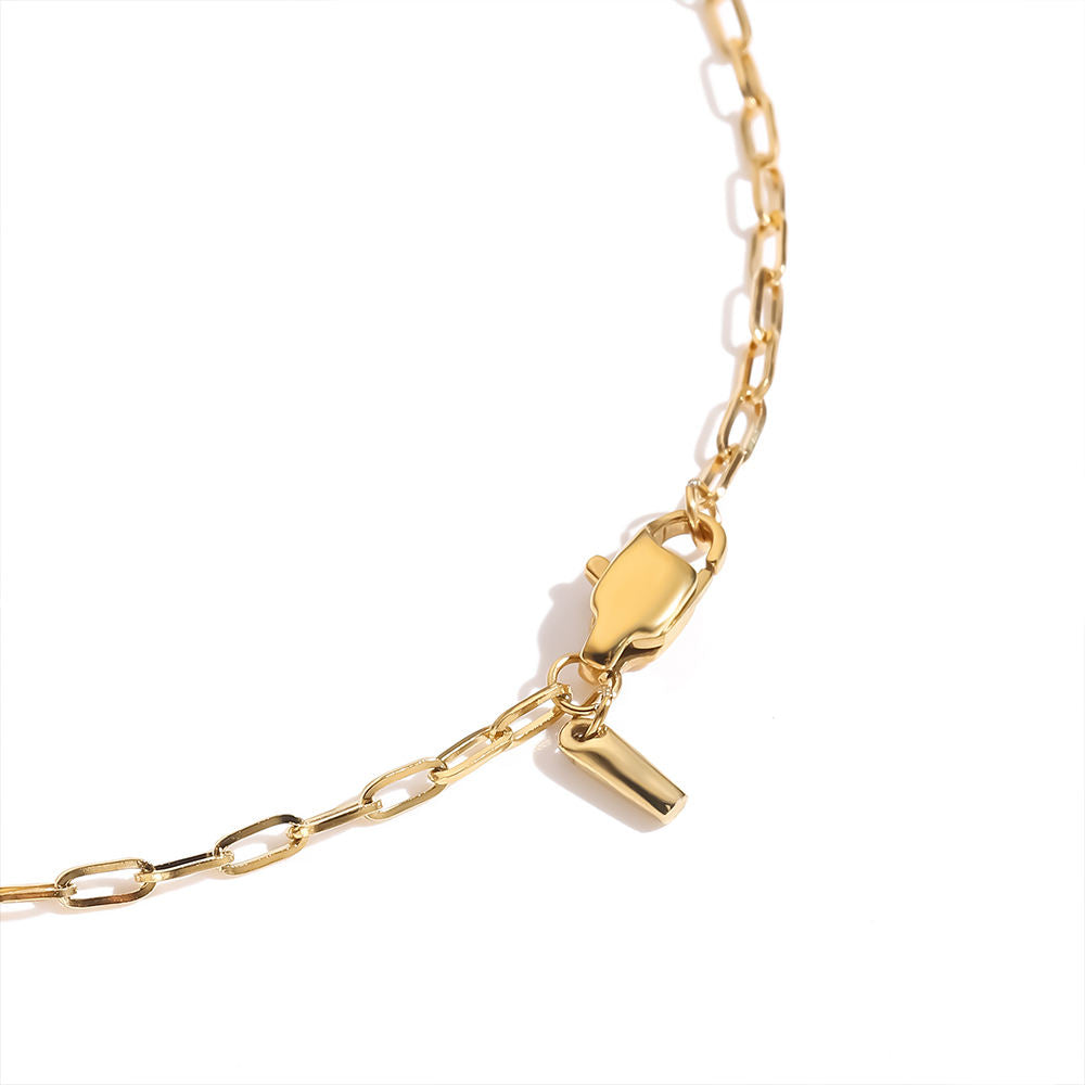 Gold chain bracelet with clasp on a white background