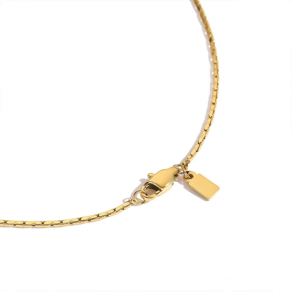 Gold bracelet with a clasp on a white background