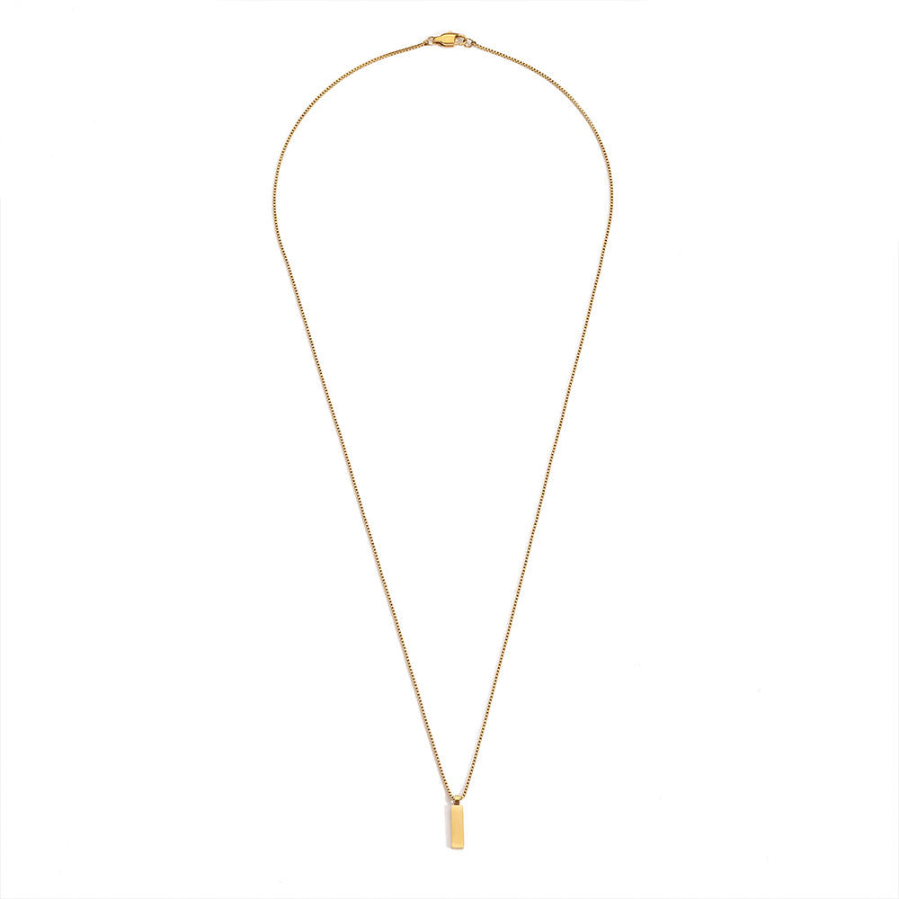 Gold necklace with a small pendant on a white background