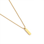 Gold necklace with a rectangular pendant on a white background