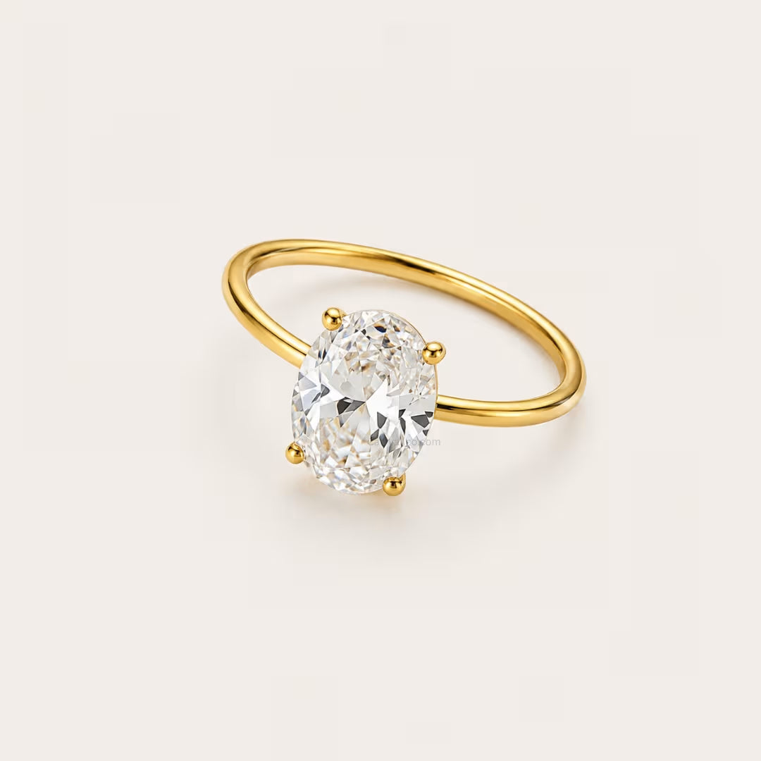 Gold ring with a large diamond on a light beige background