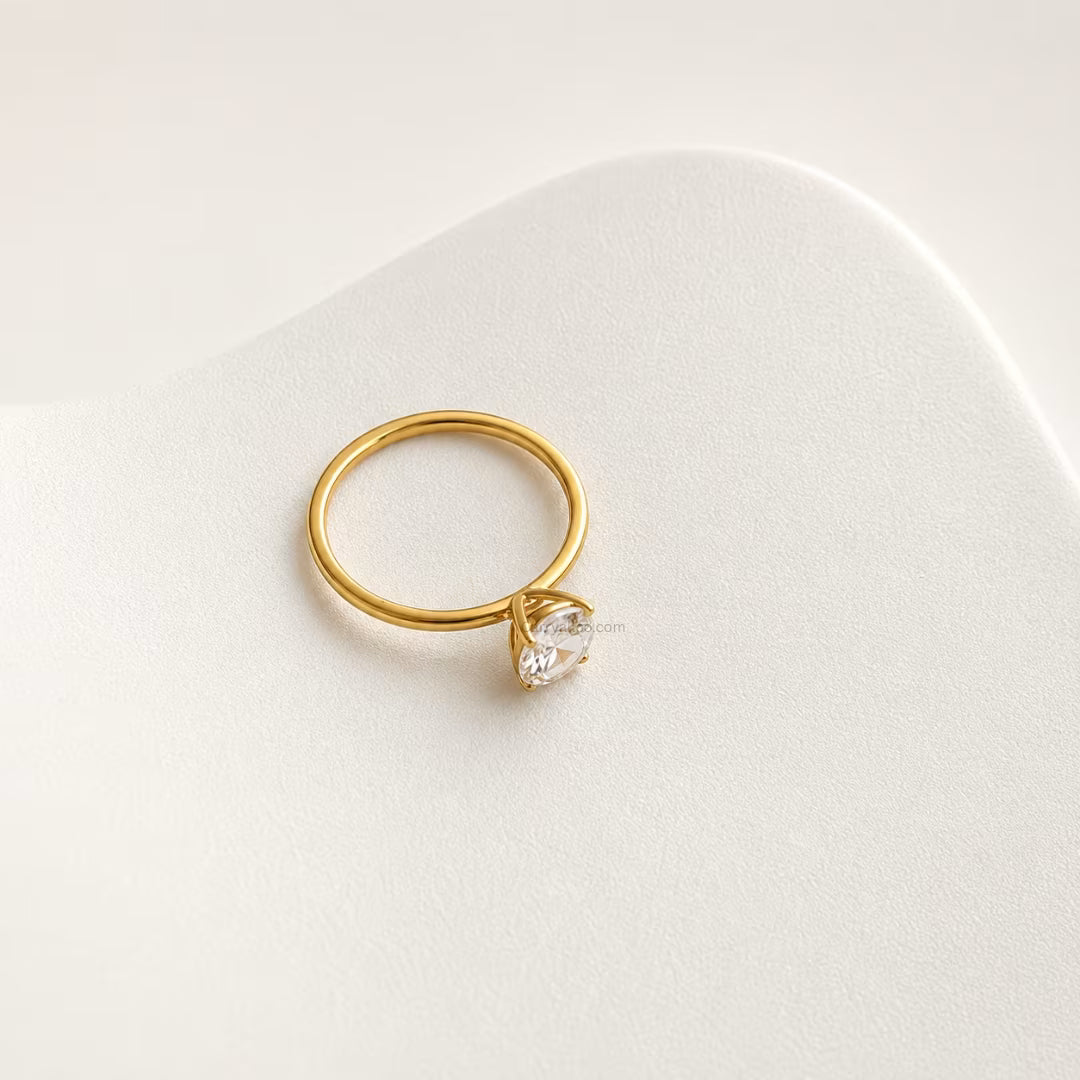 Gold ring with a diamond on a white background