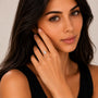 Woman wearing a diamond ring on a neutral background