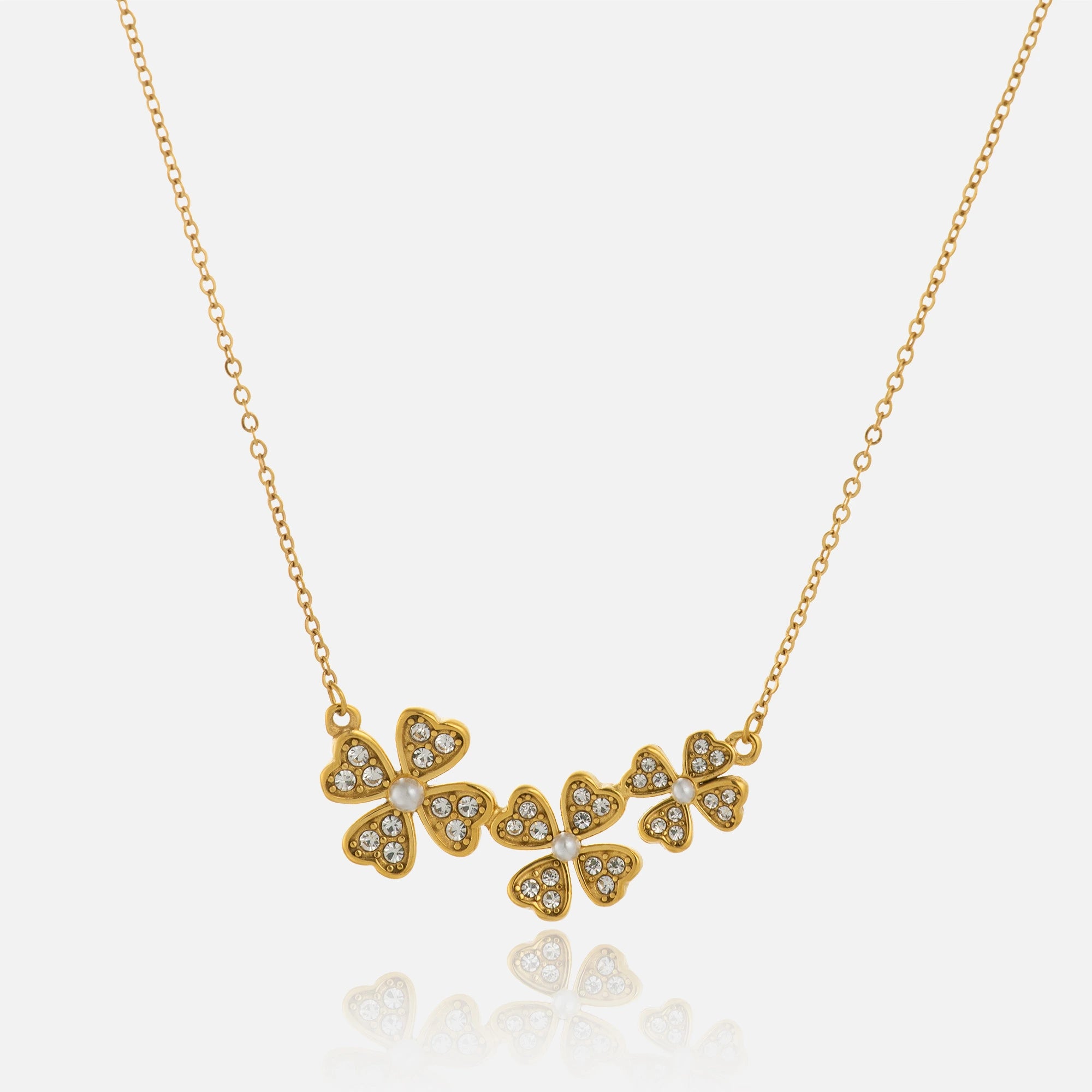 Gold necklace with floral pendants on a white background