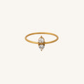 Gold ring with a small diamond on a white background