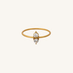 Gold ring with a small diamond on a white background