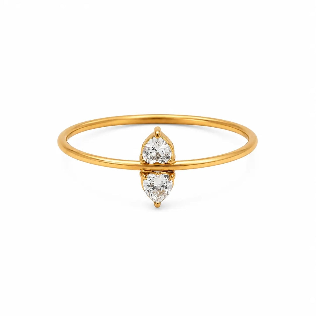 Gold bracelet with three heart-shaped diamond charms on a white background