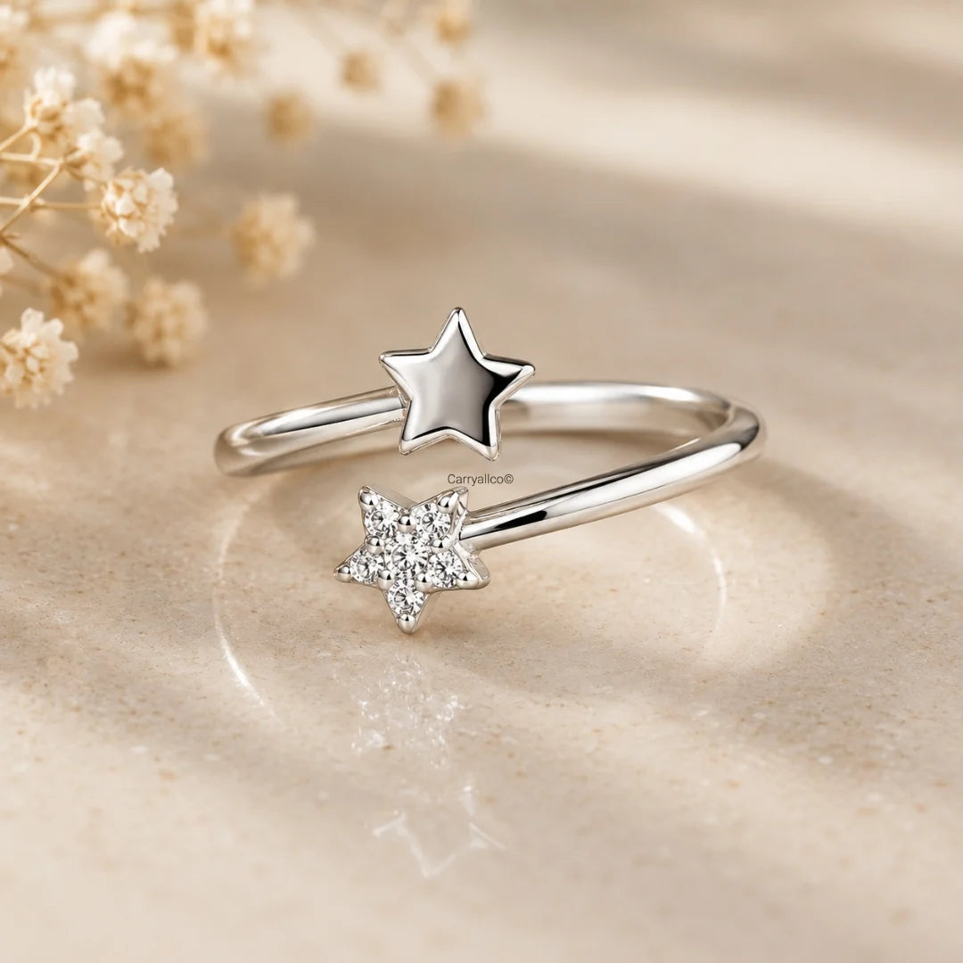 Silver ring with star designs on a beige background