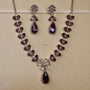 Jewelry set with necklace and earrings on a beige background