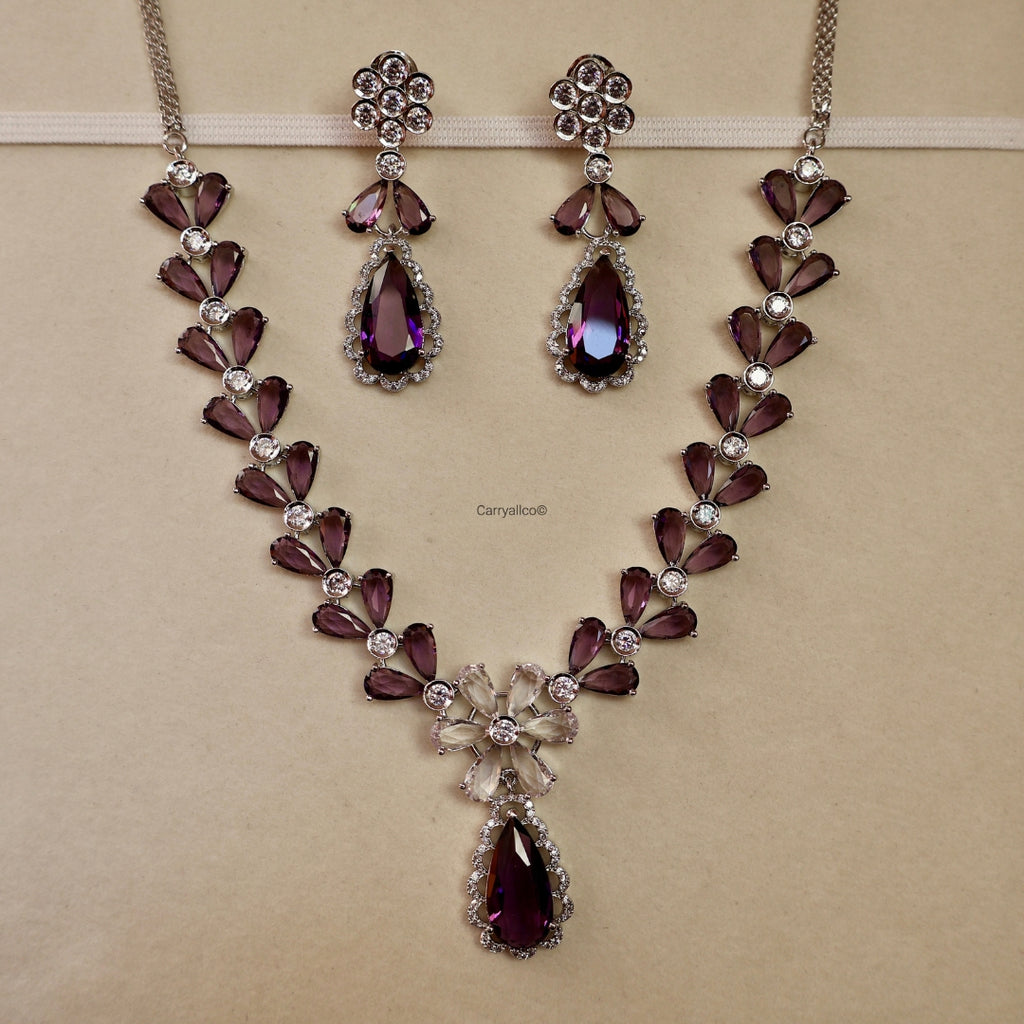 Jewelry set with necklace and earrings on a beige background