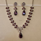 Jewelry set with necklace and earrings on a beige background