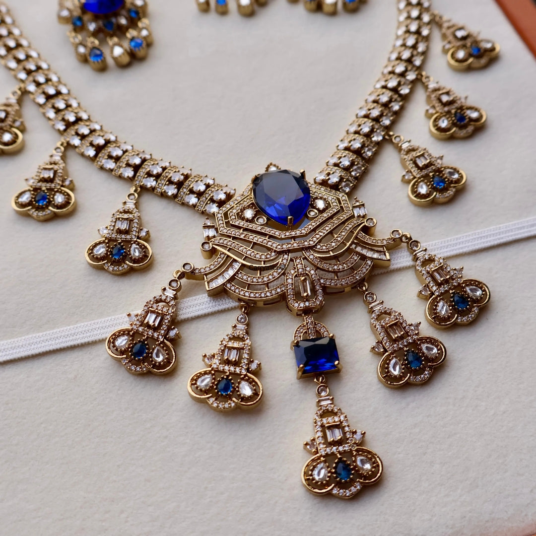 Ornate necklace with blue gemstones on a light background