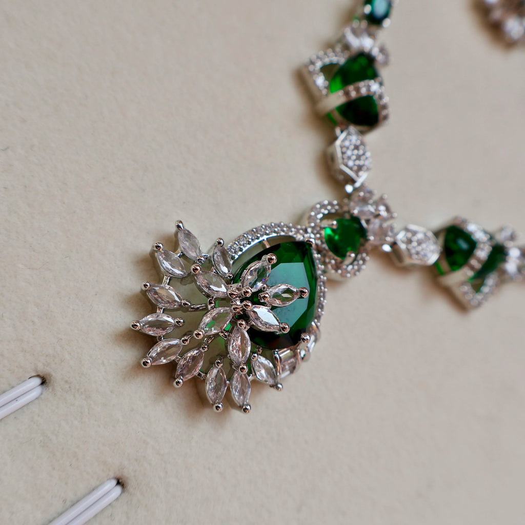 Close-up of a green gemstone necklace on a light background