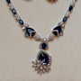 Necklace with blue gemstones and silver accents on a beige background