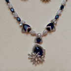 Necklace with blue gemstones and silver accents on a beige background