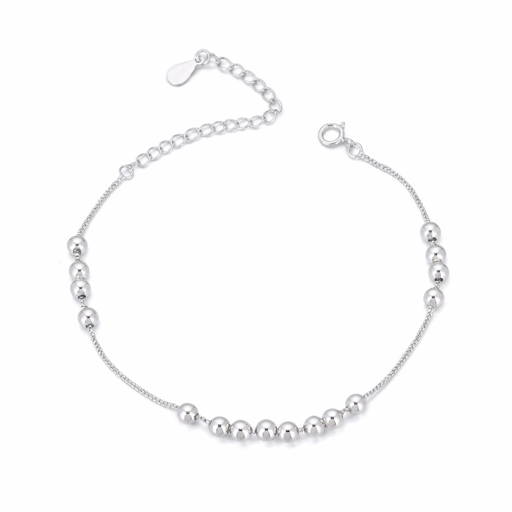 Silver bracelet with small beads on a white background