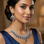 Woman wearing a luxurious diamond and sapphire necklace and earrings.