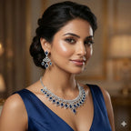 Woman wearing a luxurious diamond and sapphire necklace and earrings in an elegant setting.