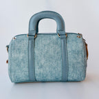 Blue handbag with gold accents on a white background