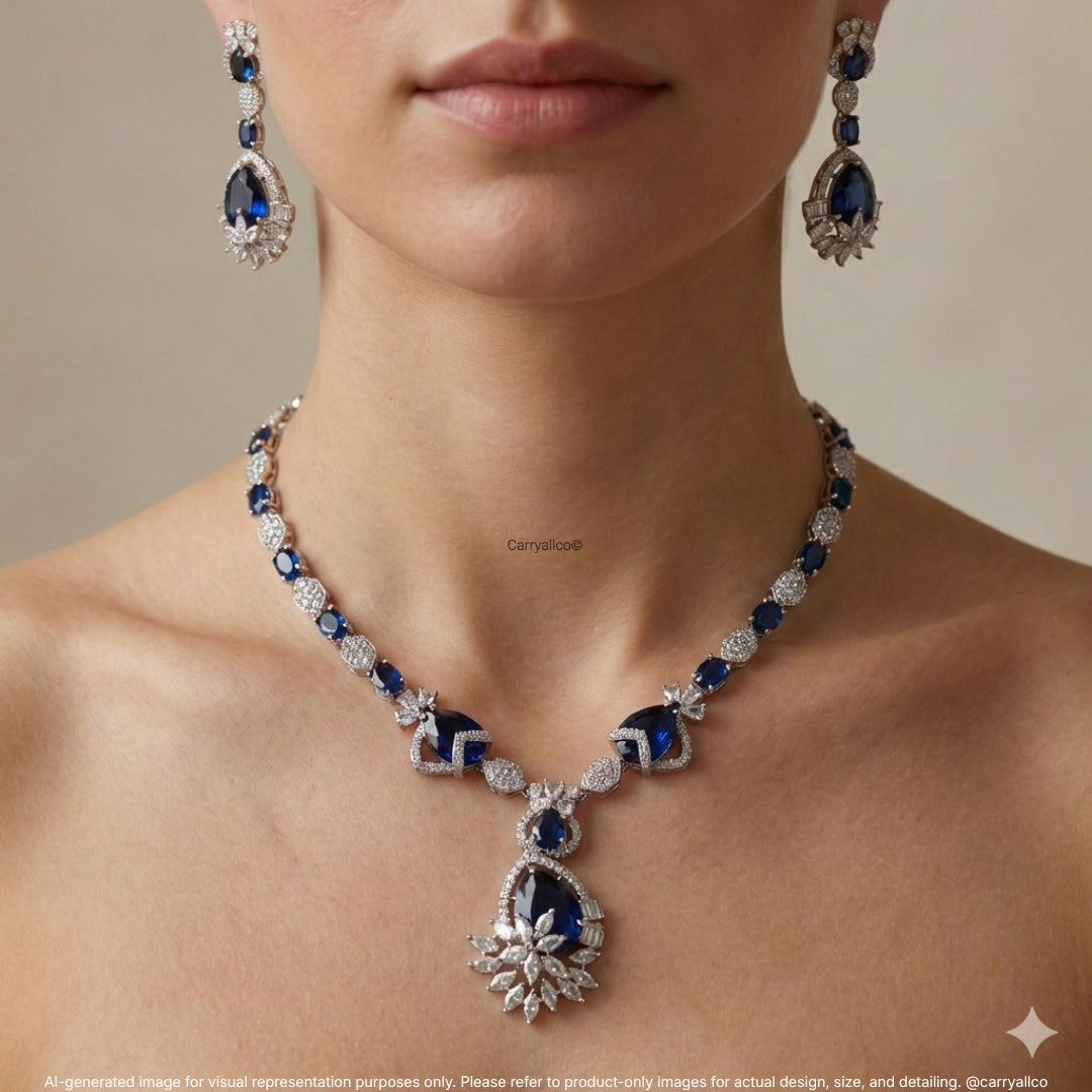 Luxury jewelry set with necklace and earrings featuring blue and white stones on a neutral background.