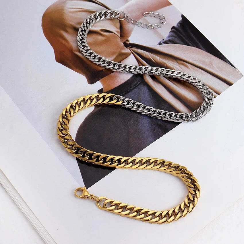Gold and silver chain necklaces on a magazine background