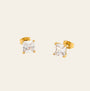 Gold stud earrings with clear gemstones on a white background