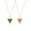 Gold necklaces with green and pink gemstone pendants on a white background
