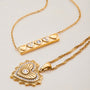 Gold necklace with heart-shaped pendant on a light background