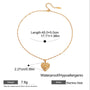 Gold necklace with heart pendant and measurement details on a white background