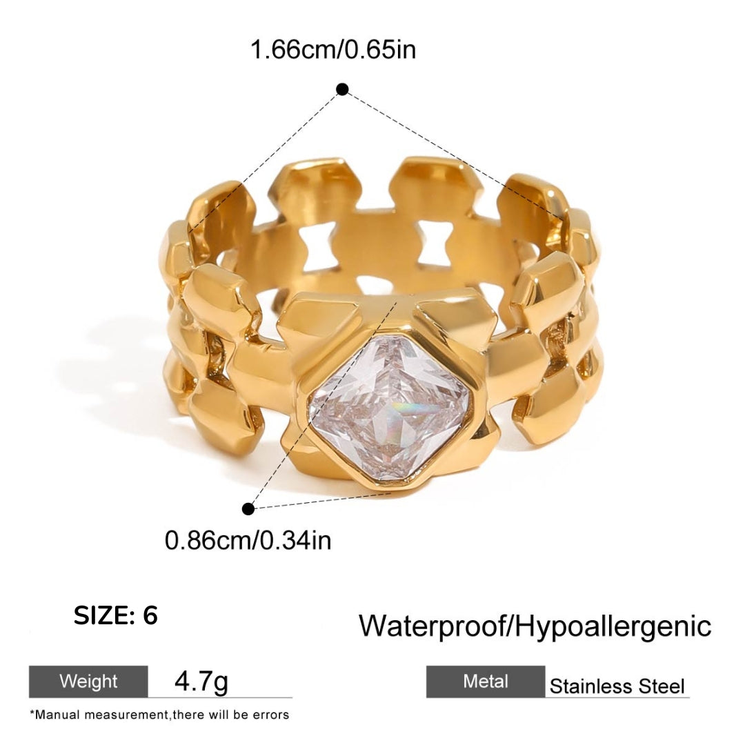 Gold ring with geometric design and clear gemstone, showing measurements and material details.