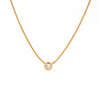 Gold necklace with a small round pendant on a white background