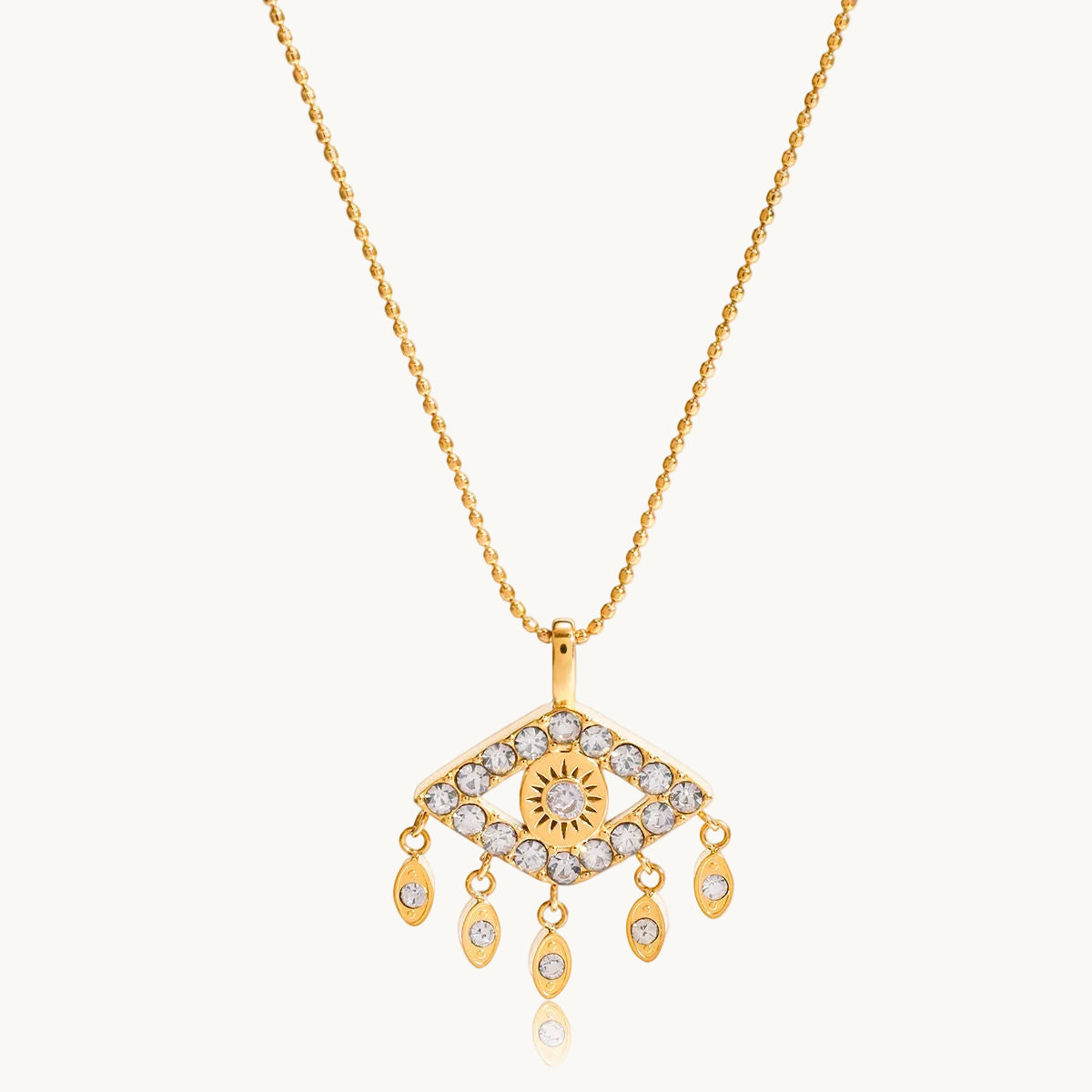Gold necklace with an eye-shaped pendant on a white background