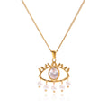 Gold necklace with an eye-shaped pendant and pearl accents on a white background