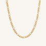 Gold chain necklace on a light gray background