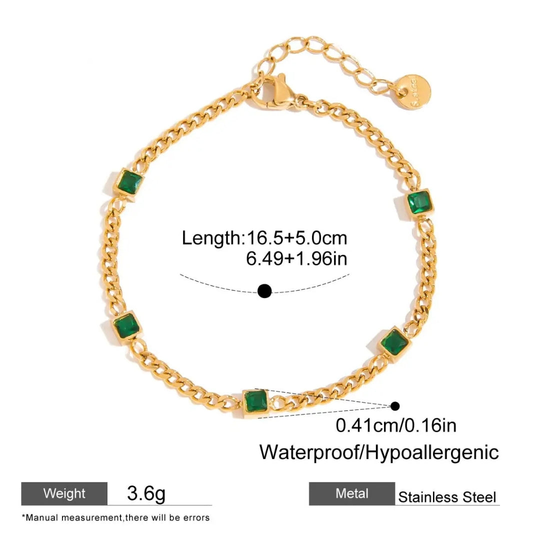 Gold bracelet with green stones and measurement details on a white background