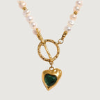 Necklace with heart-shaped green gemstone pendant on a white background
