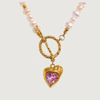 Necklace with a heart-shaped pink gemstone pendant on a light gray background