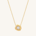 Gold necklace with a diamond pendant on a white background