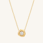 Gold necklace with a diamond pendant on a white background