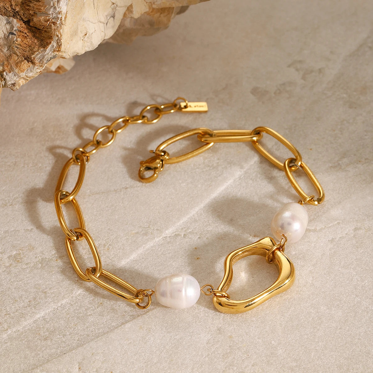 Gold necklace with a pearl pendant, labeled 'CARRYALCO', on a white background.