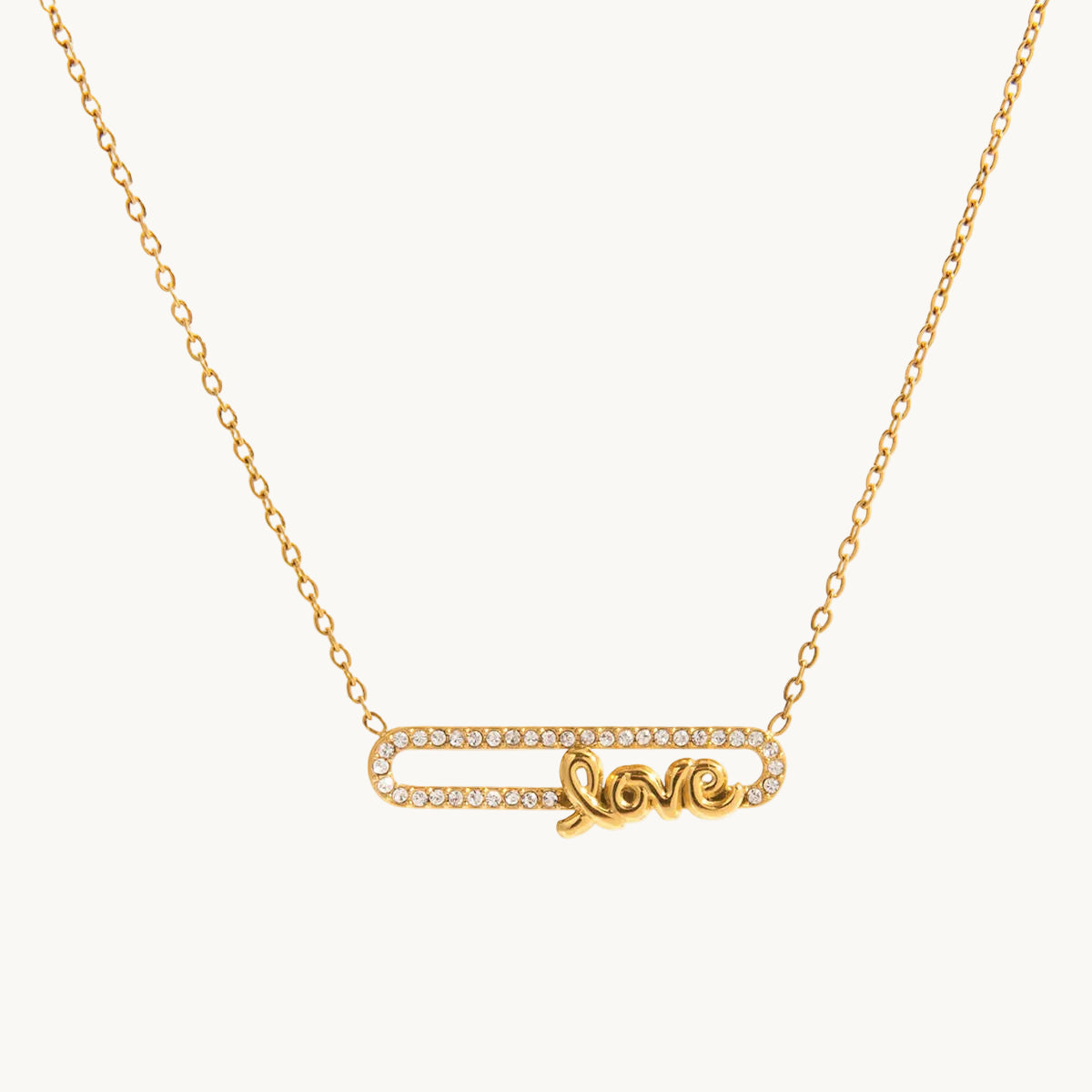 Gold necklace with 'love' pendant on a white background