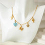 Gold necklace with charms on a mannequin bust