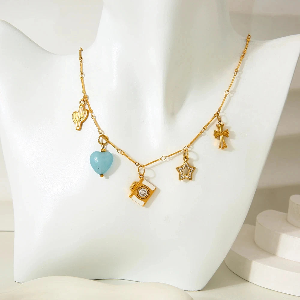 Gold necklace with charms on a mannequin bust
